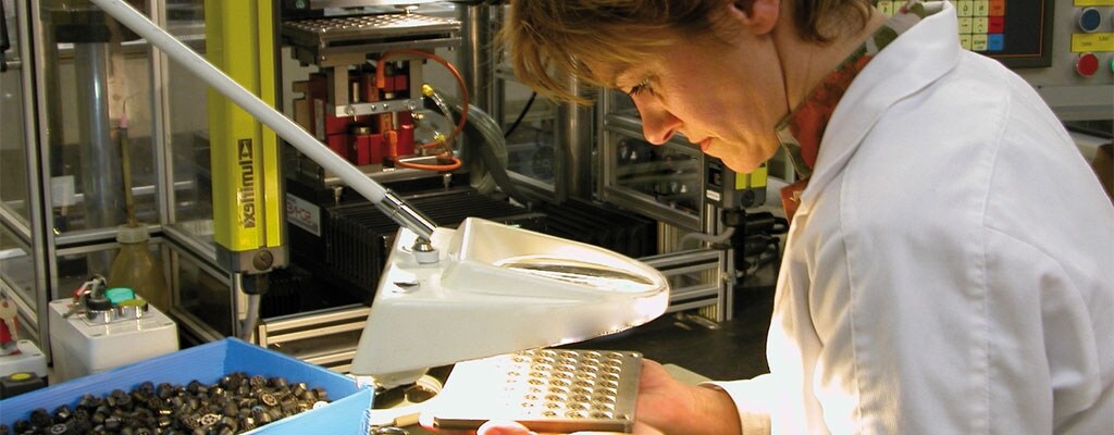woman checking pin contacts on connectors