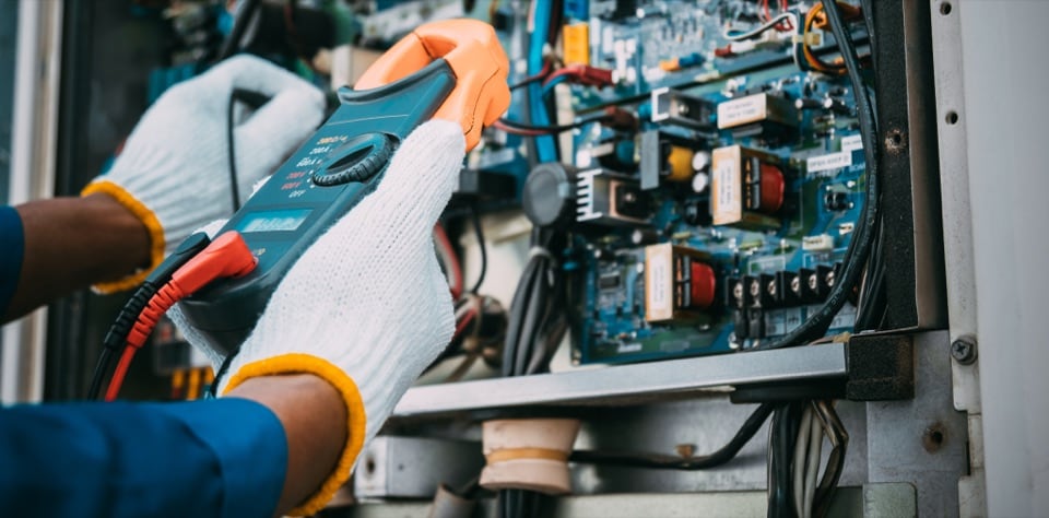 Technician testing an HVAC control board