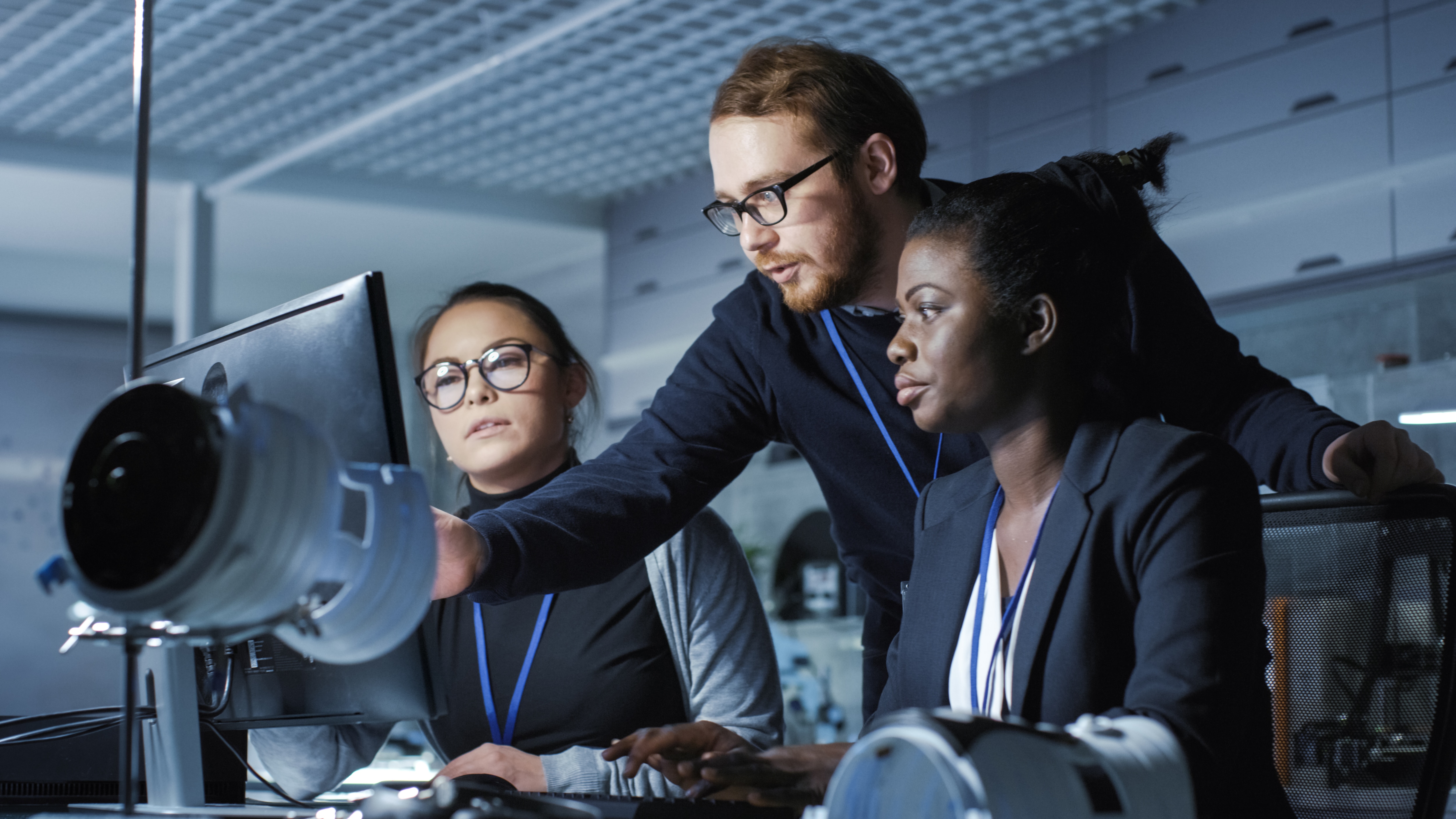 Engineers reviewing a performance report in a data control room.