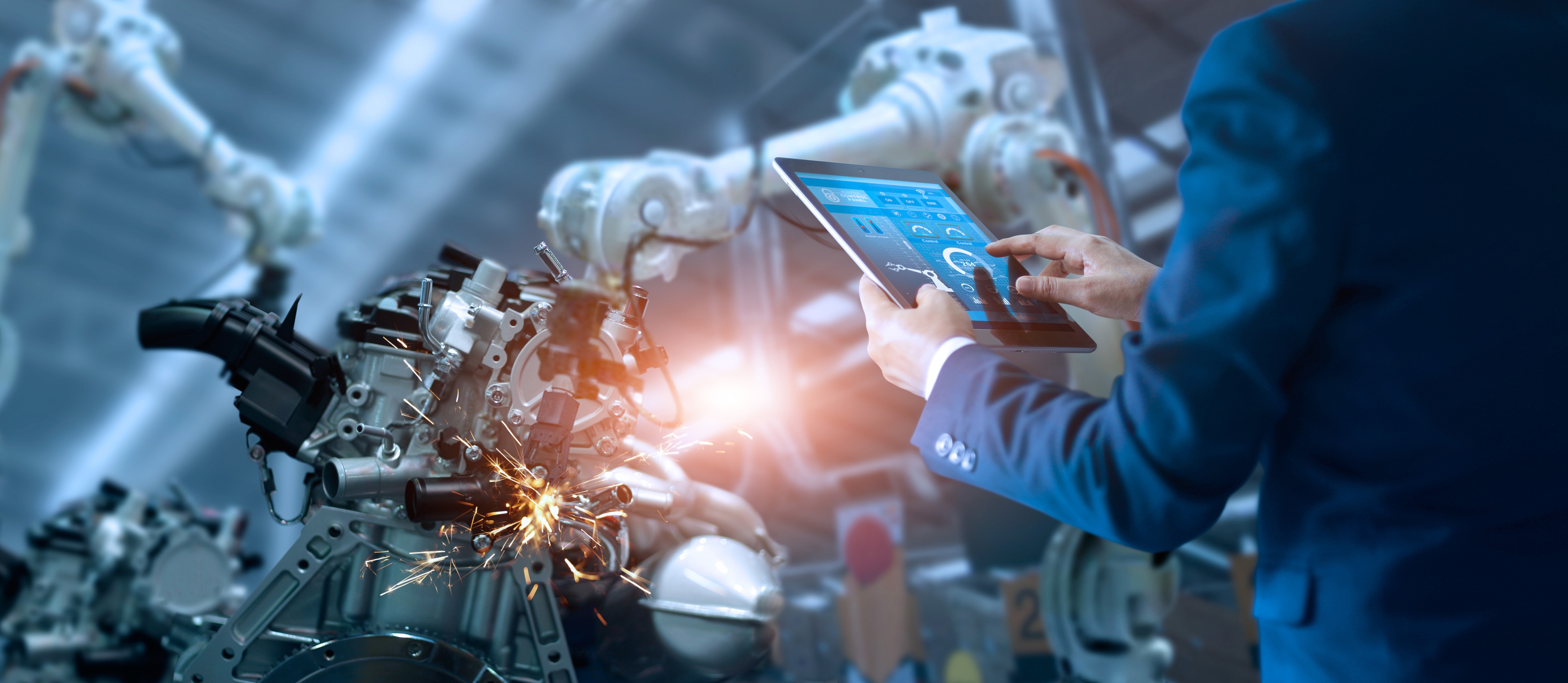 Engineer operating AI technology to run industrial robots on the factory floor.