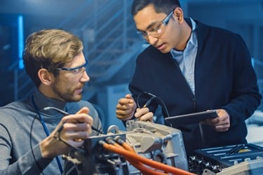 Automotive engineers working on EV battery connection system in the research laboratory.