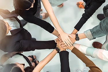 Group of hands celebrating diversity