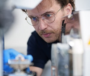 Employee focusing intently on a product