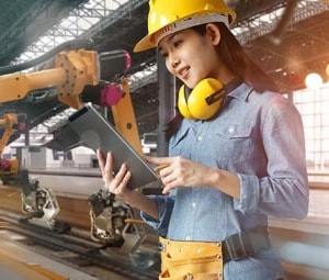 Female engineer works with a cobot in a factory.