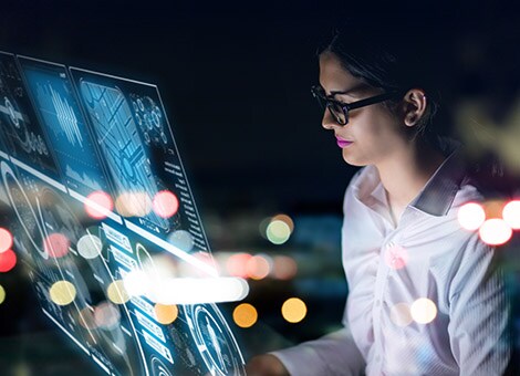 Woman looks at a virtual interactive touch screen computer.