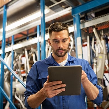 A man operates software powering factory automation.