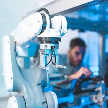 Engineer builds cobots in a factory.