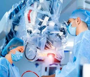   Surgeons perform a minimally invasive medical procedure.