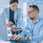 Engineer operates factory cobots on the factory floor.