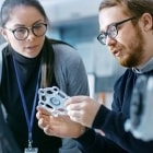 Materials scientists in a materials science laboratory examine a 3D-printed prototype.
