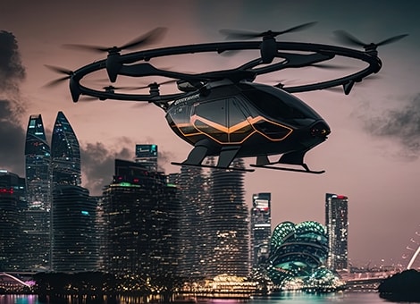 eVTOL traveling through a city at sunset.