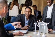 Engineers in a design lab discuss supply chain dynamics.