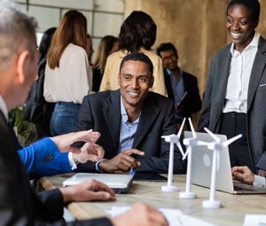 Engineers in a design lab discuss supply chain dynamics.