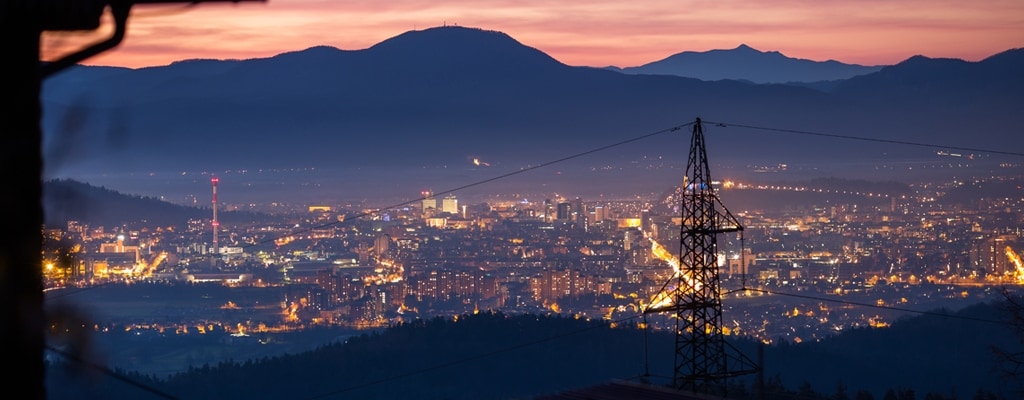 city by night with overhead lines