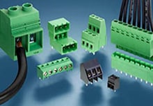 Several green terminal block connectors on a blue background