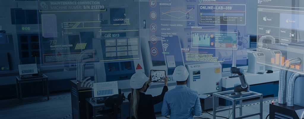 Two engineers wearing hard hats looking out over an automated smart factory floor with futuristic digital data and connectivity overlays.